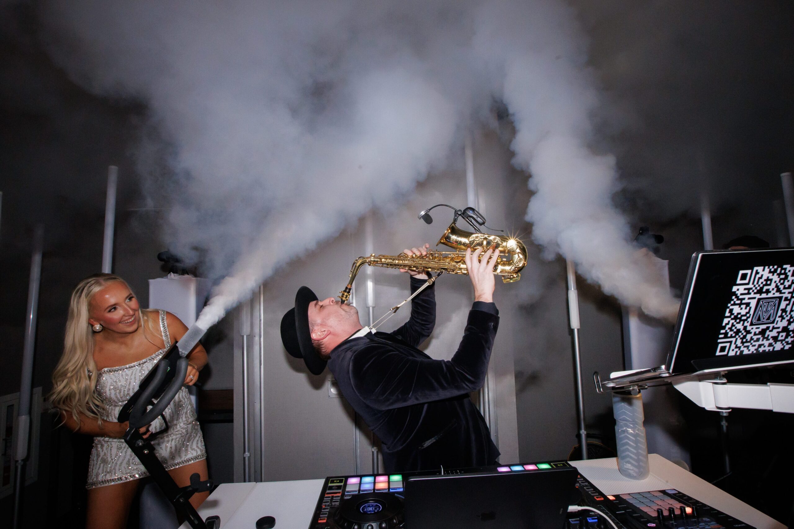 Matt Thelen playing live saxophone alongside DJ setup at a Dallas wedding reception